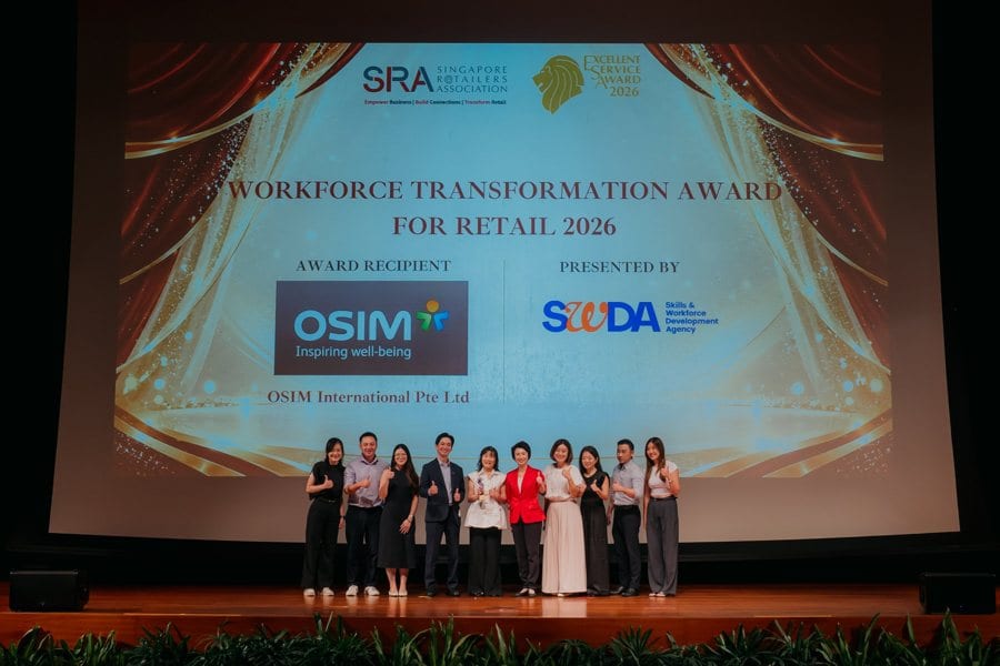 The OSIM International team celebrating on stage